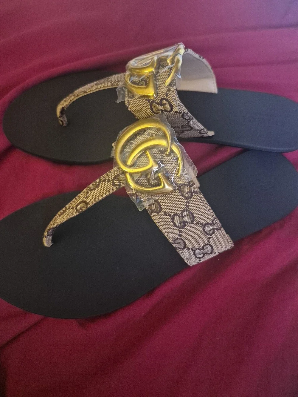 Source Unknown Black Thong Sandals with Gold Emblem and Beige Patterned Straps